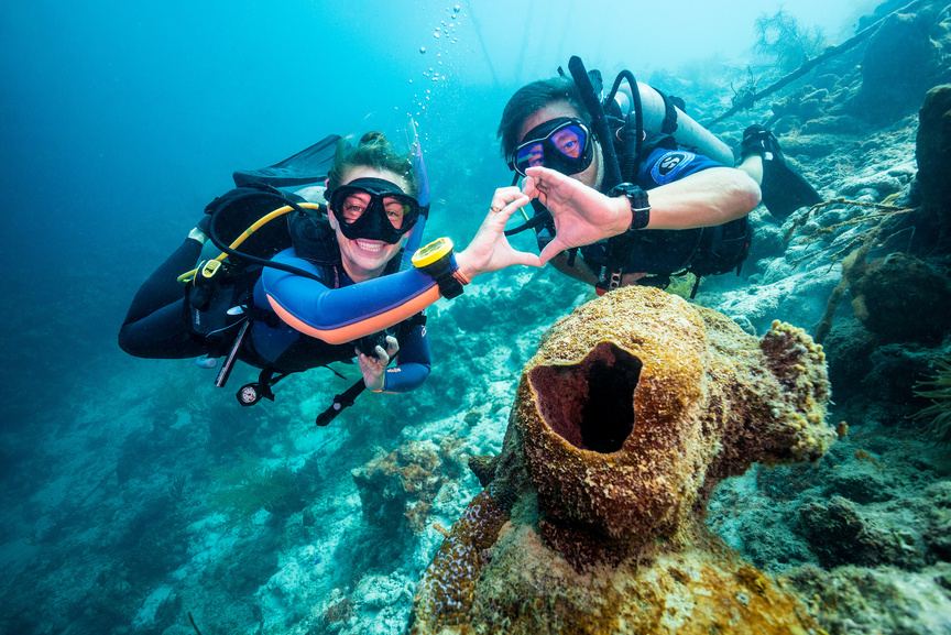 Two divers forming a heart above an amphora